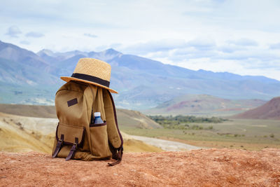 Full length of senior woman on arid landscape against sky