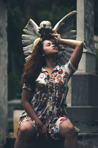 Young woman holding umbrella