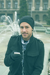 Portrait of young man standing outdoors