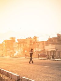 Rear view of man walking on street in city