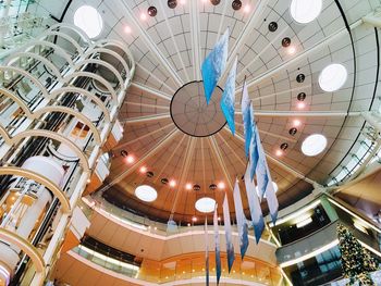 Low angle view of illuminated chandelier in shopping mall