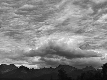 Scenic view of mountains against cloudy sky