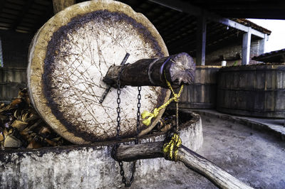 Close-up of old pipe on wood by building