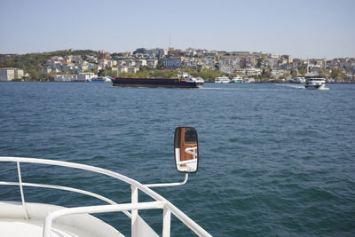 Boats in sea against clear sky