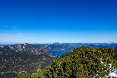 Scenic view of mountains against blue sky