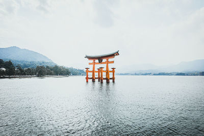 Lifeguard hut in lake against sky