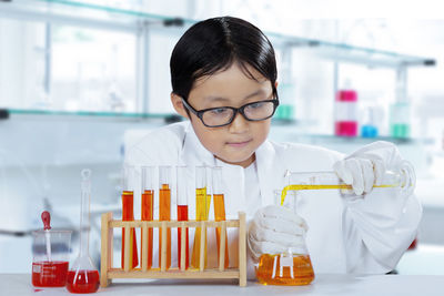 Boy doing experiment in laboratory