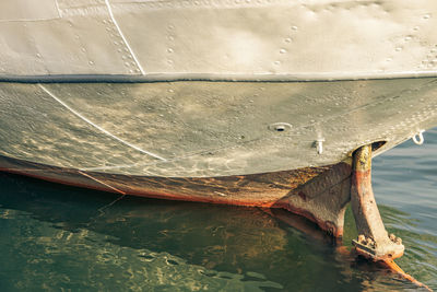 Close-up of fishing boat moored in sea