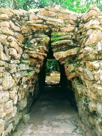 Narrow alley amidst rocks and wall