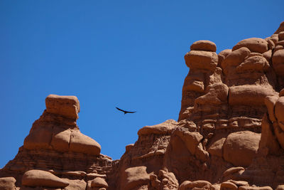 Low angle view of sculpture against clear blue sky