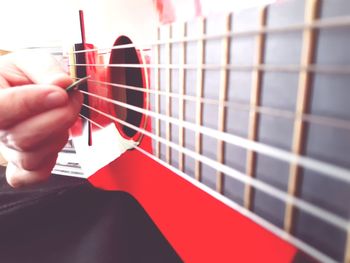 Close-up of hand holding guitar