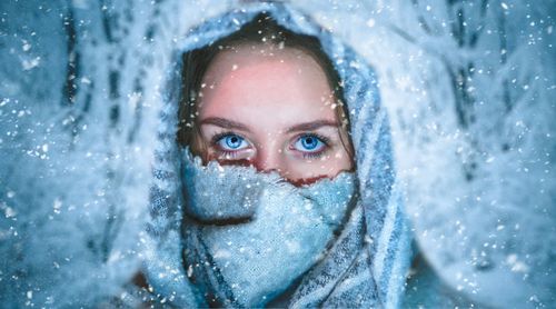 Portrait of mature woman with snow covered face