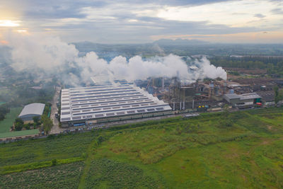 Aerial view of buildings on field against sky