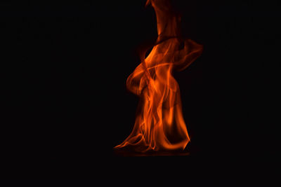 Close-up of bonfire burning against black background