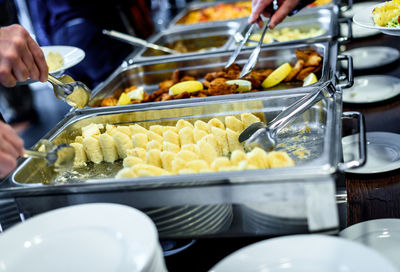 Cropped image of hands taking food