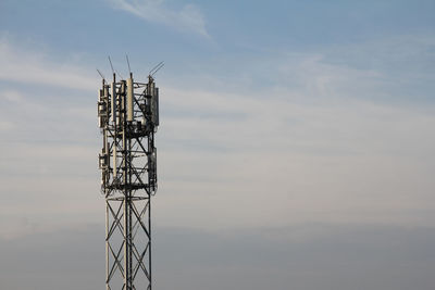 Low angle view of communications tower against sky