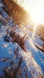 Low angle view of snow on mountain during sunset