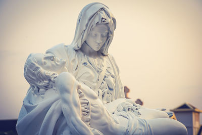 Low angle view of statue against sky