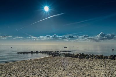 Scenic view of beach against blue sky