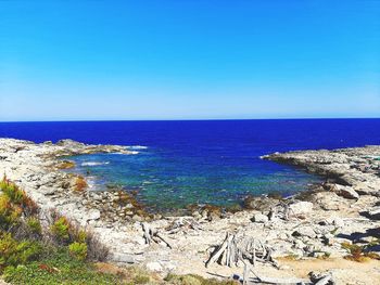 Scenic view of sea against clear blue sky