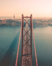 View of bridge over sea at sunset