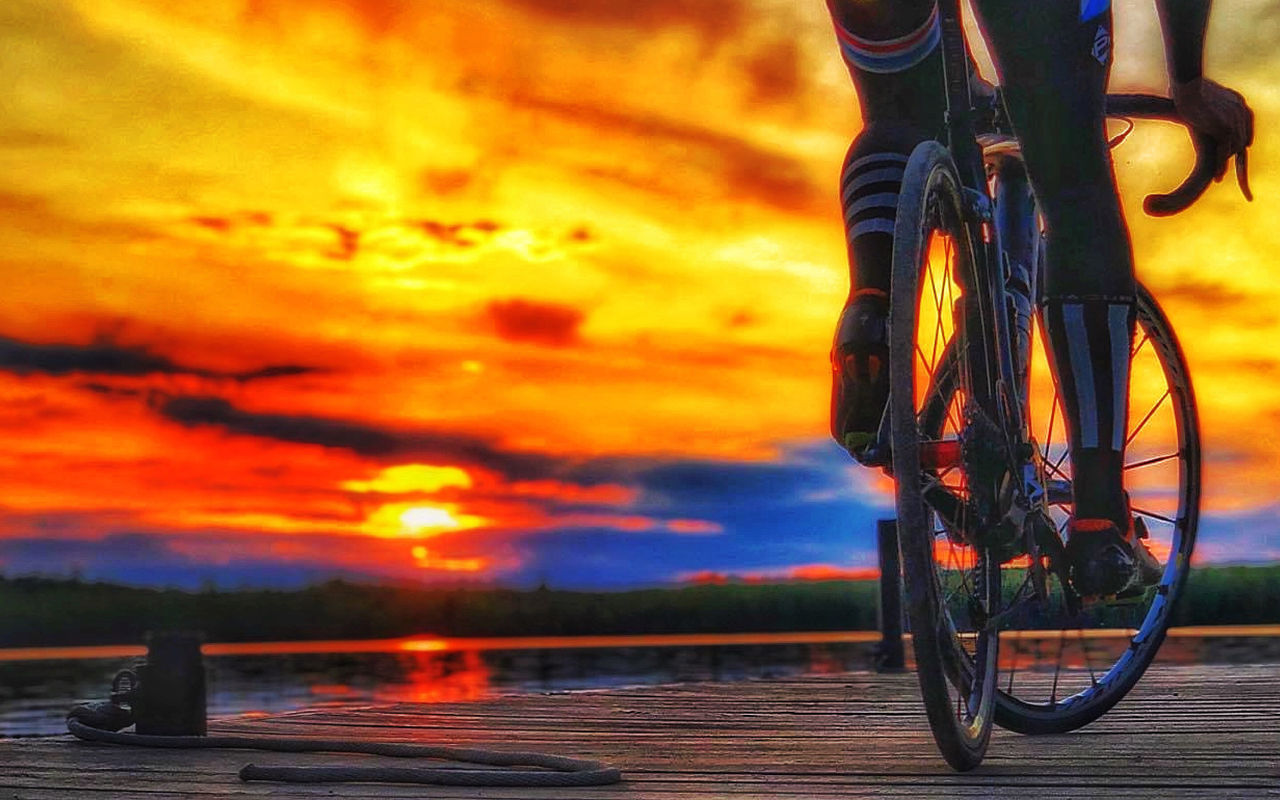 sunset, transportation, orange color, sky, bicycle, cloud - sky, mode of transportation, land vehicle, nature, beauty in nature, no people, outdoors, wheel, water, scenics - nature, focus on foreground, close-up, travel, low section, tire, spoke