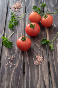 High angle view of fresh tomatoes and cilantro on table