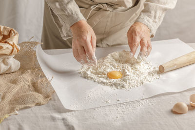 Midsection of woman with cookies on table