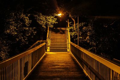 Illuminated footbridge at night