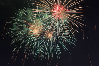 Low angle view of firework display at night