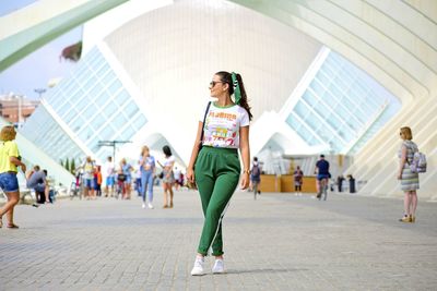 Full length portrait of woman standing outdoors