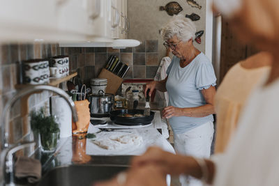 Senior woman preparing food in kitchen