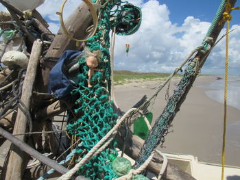 Fishing boats moored at shore against sky