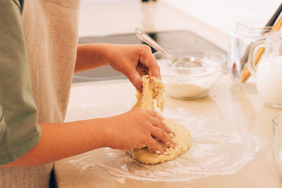 Midsection of man washing hands in sink