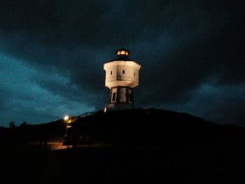 Low angle view of lighthouse against sky at night