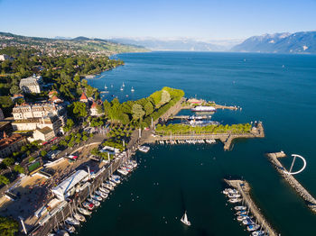 High angle view of buildings by sea against sky