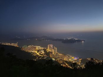 High angle view of illuminated cityscape against sky at night