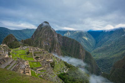 Scenic view of mountain against cloudy sky