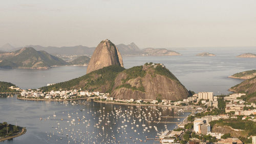 Scenic view of sea and mountains against clear sky