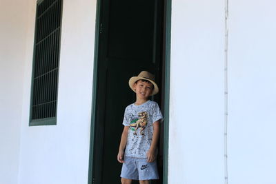 Portrait of boy standing at doorway
