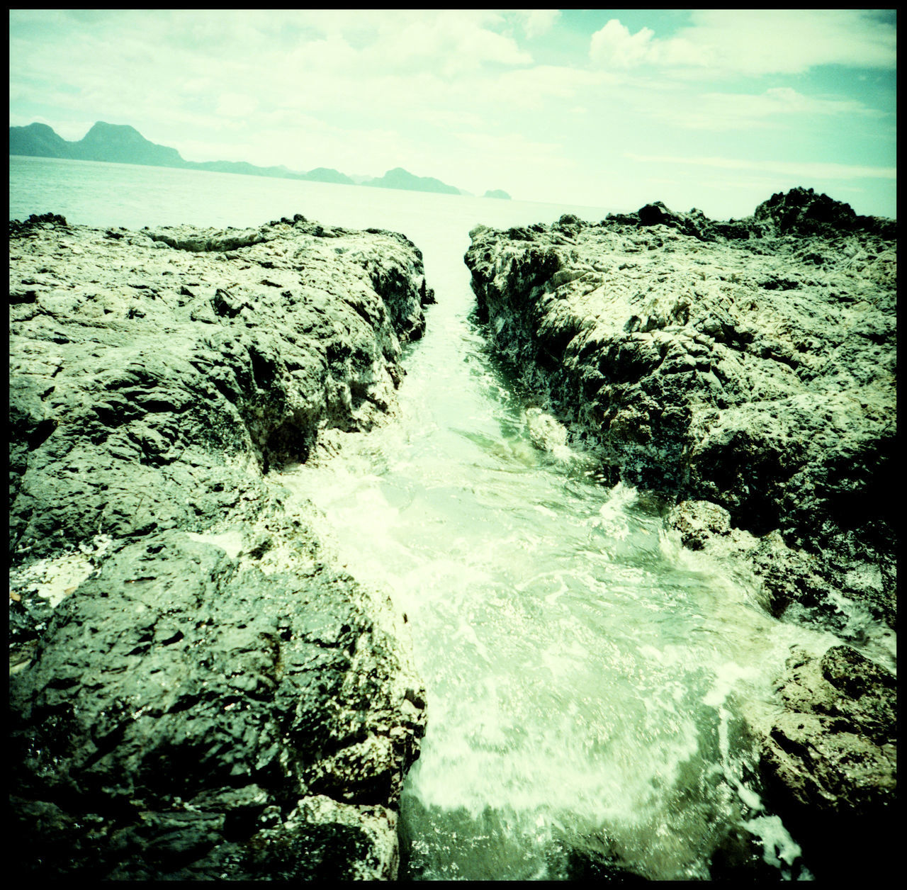 SCENIC VIEW OF WATER FLOWING AGAINST SKY