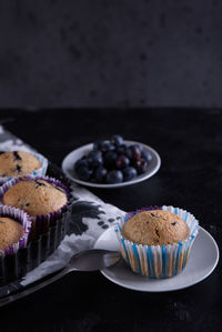 Delicious homemade cupcakes filled with blueberries and presented in small molds.