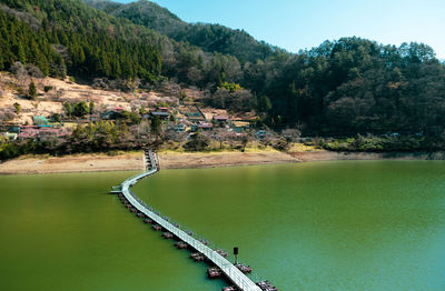 Long exposure of pontoon bridge crossing lake okutama