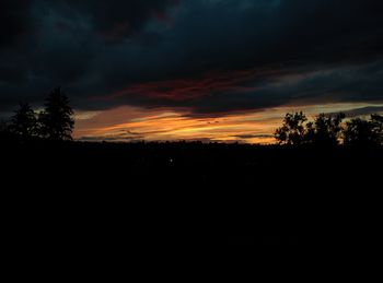 Silhouette of landscape against cloudy sky