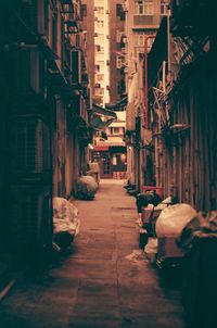 People on narrow alley amidst buildings in city