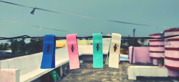 Clothes drying on rope against blue sky