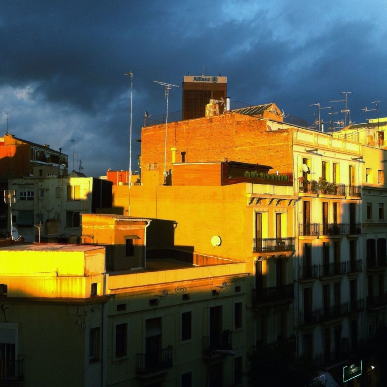 building exterior, architecture, built structure, sky, cloud - sky, residential building, residential structure, city, cloudy, building, low angle view, yellow, cloud, house, sunset, residential district, outdoors, no people, overcast, illuminated