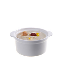 Close-up of fruits in bowl over white background