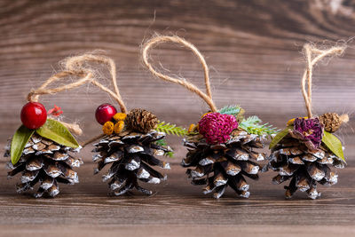 Handmade christmas tree toys made of pine cones, decorated with natural materials.