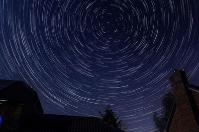 Low angle view of fireworks against sky at night